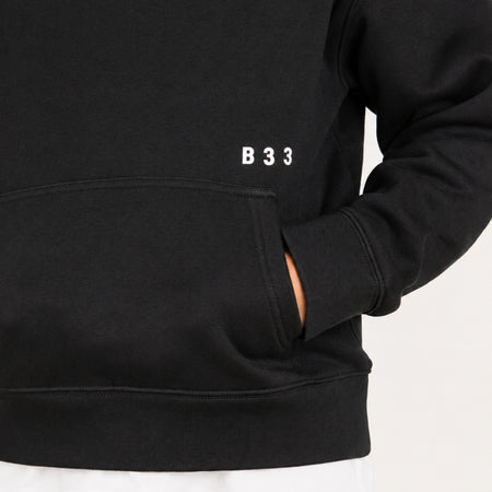 Bee Inspired Junior Initial Hoodie in Black, relaxed fit junior hoodie, close-up crop shot
