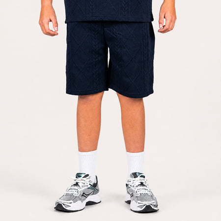Bee Inspired Junior Konsa Twin Set in Navy, matching polo shirt and shorts twin set in lightweight cotton, close-up crop shot