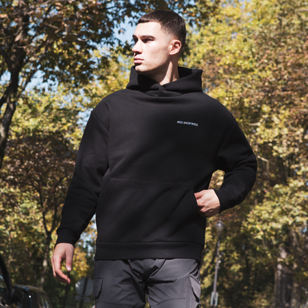 Bee Inspired Stach Hoodie in Black, relaxed fit hoodie with a kanga pocket and stretch cuffs, styled lifestyle shot