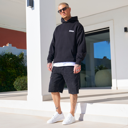 Bee Inspired Aguirre Hoodie in Black/Blue, relaxed fit hoodie with a raised graphic print and kanga pocket, styled shot