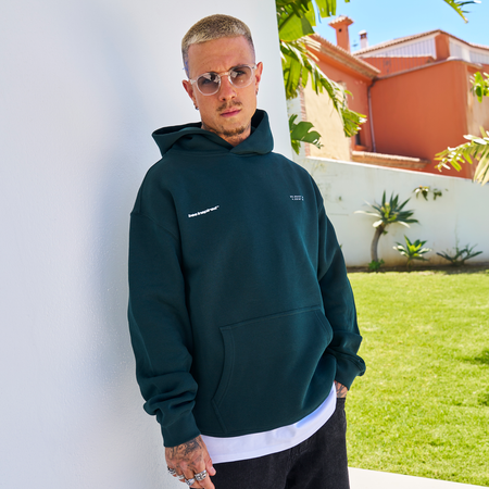 Bee Inspired Mata Hoodie in Pine Green, oversized hoodie with a bold rear graphic print, close-up