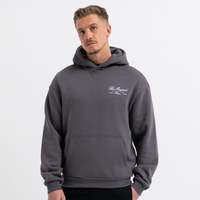 Man wearing a grey hoodie with a logo on a white background