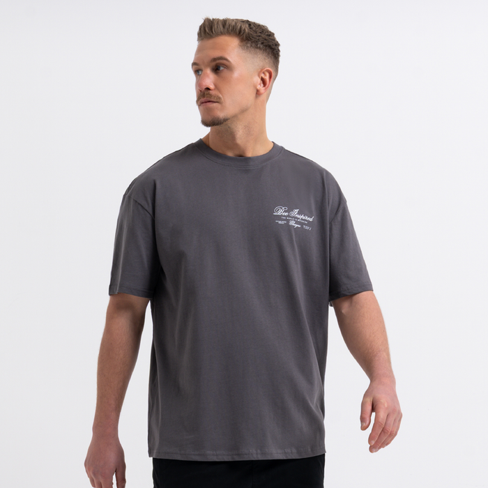 Man wearing a grey t-shirt with a logo on a white background