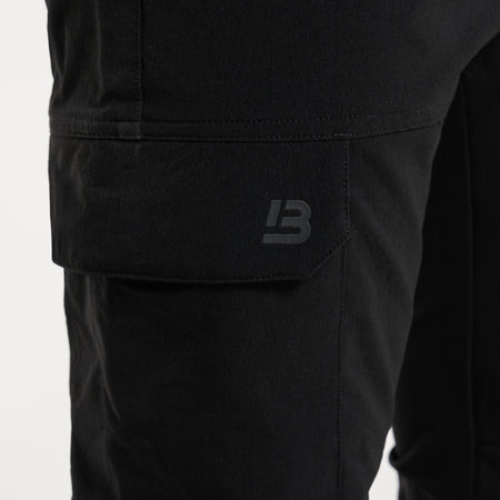 Close up of multiple utility pockets on the Rivero Tech Cargo Pants in black