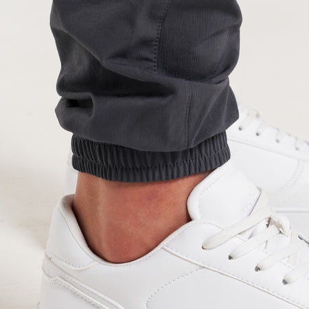 Rivero Tech Cargo Pants in charcoal, focusing on stretch ankle cuffs