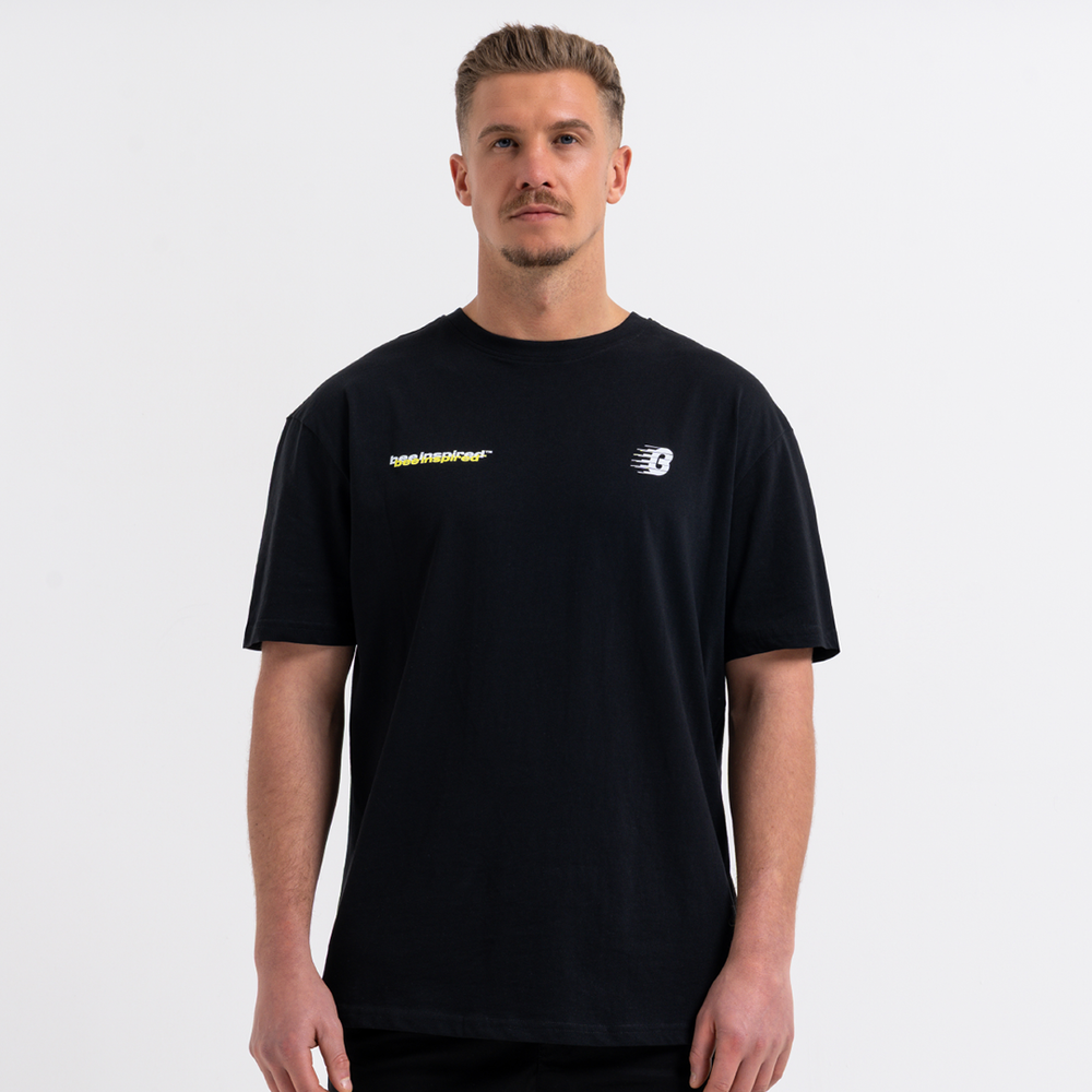 Man wearing a black t-shirt with logos on a white background