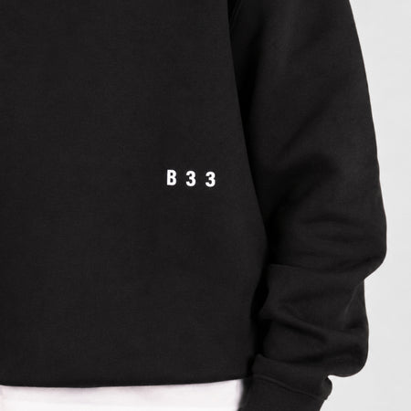 Bee Inspired Junior Initial Crew in Black, relaxed fit junior crew sweatshirt, close-up crop shot