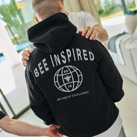 Bee Inspired Sagna Hoodie in Black, relaxed fit hoodie with a bold back graphic, back view