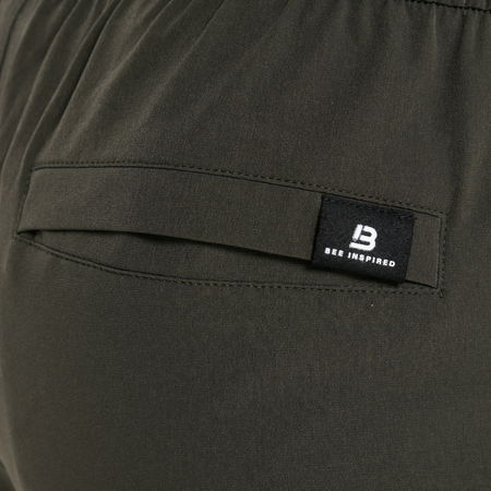 Bee Inspired Merola Pant in Khaki, regular fit trousers with a branded back pocket label, close-up