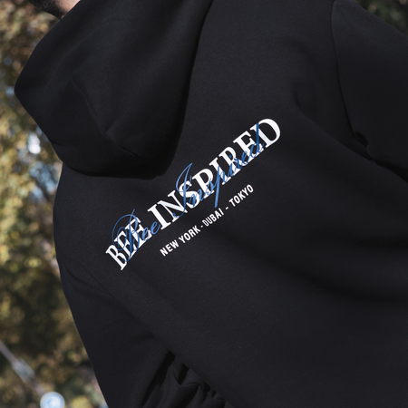 Bee Inspired Stach Hoodie in Black, relaxed fit hoodie with a kanga pocket and stretch cuffs, styled lifestyle shot
