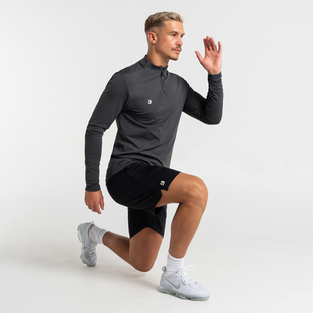 Bee Inspired Signature Sports 1/4 Zip in Charcoal, quarter-zip sports top with a thumb hole in the sleeve, close-up