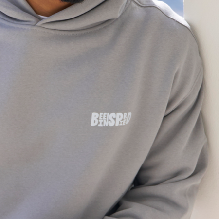 Bee Inspired Aguirre Hoodie in Grey/Pink, relaxed fit hoodie with a raised graphic print and kanga pocket, close-up