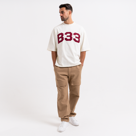 Bee Inspired Figo T-Shirt in Off White, heavyweight cotton tee with a large twill fabric appliqu\u00e9, close-up