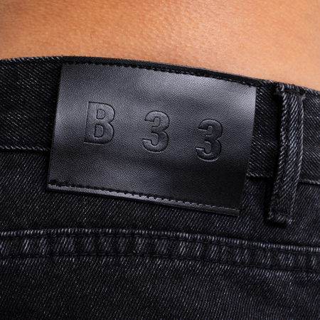 Bee Inspired Garnacho Relaxed Jeans in Washed Black, heavyweight denim jeans with rip detailing for a worn-in look, close-up