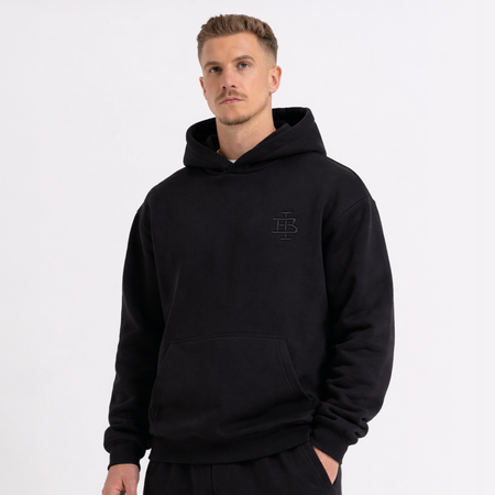 Bee Inspired Guedes Hoodie in Black, hoodie with a clean embroidered BI monogram graphic, close-up crop shot