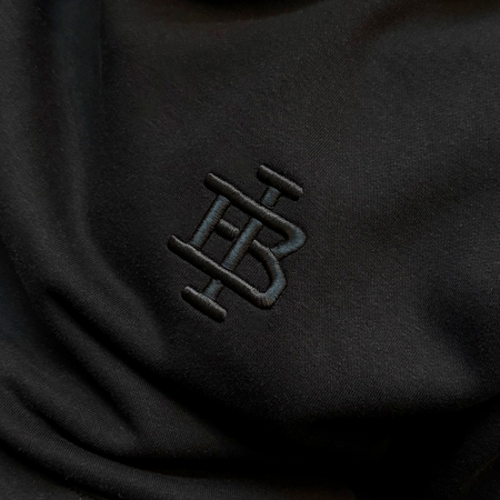 Bee Inspired Guedes Hoodie in Black, hoodie with a clean embroidered BI monogram graphic, styled lifestyle shot