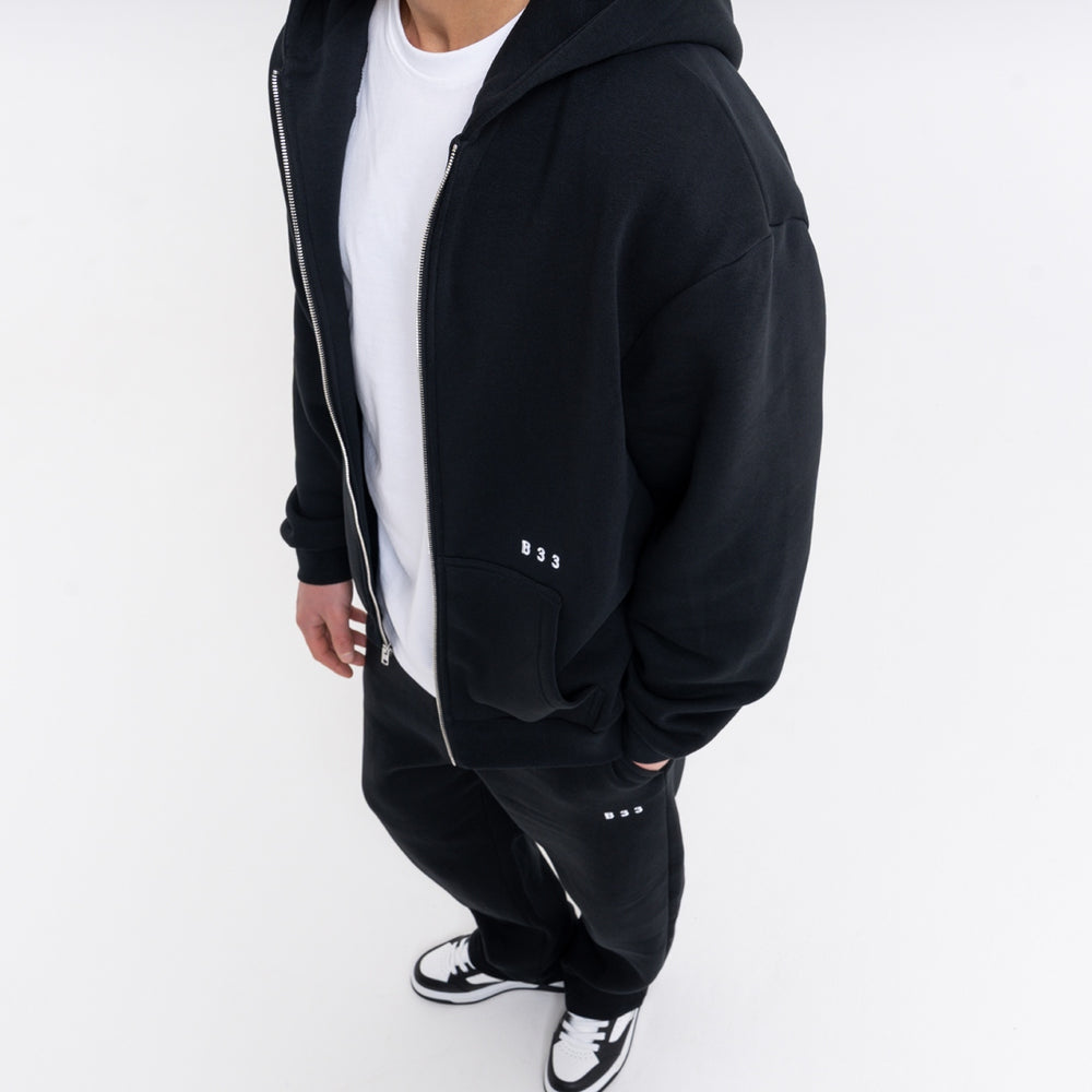 Initial Jogpant in black with embroidered B33 branding, shown as a tracksuit