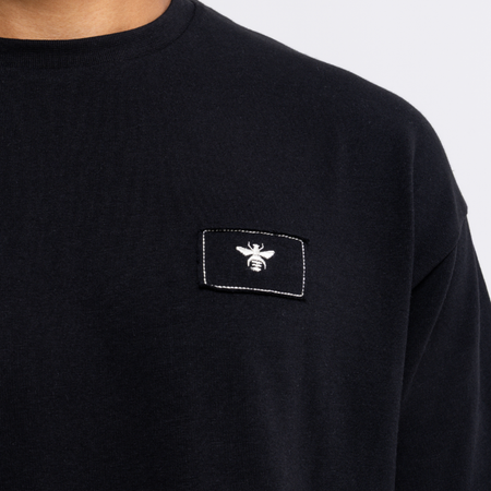 Legacy Logo T-Shirt in black, focusing on the Legacy front design