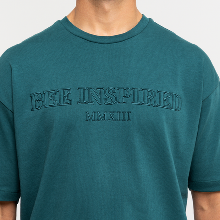 Bee Inspired Levit T-Shirt in Teal, tee with embroidered branding across the chest, close-up