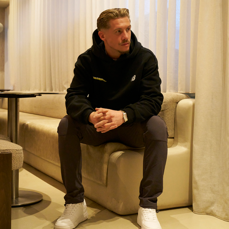 Bee Inspired Scholes Hoodie in Black, relaxed fit hoodie with stretch cuffs and hem, styled lifestyle shot