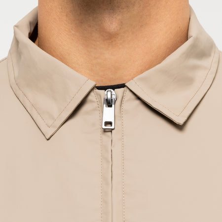 Marshall Jacket in dark sand, focusing on bold B33 branding on the upper back