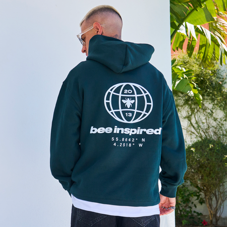 Bee Inspired Mata Hoodie in Pine Green, oversized hoodie with a bold rear graphic print, front view