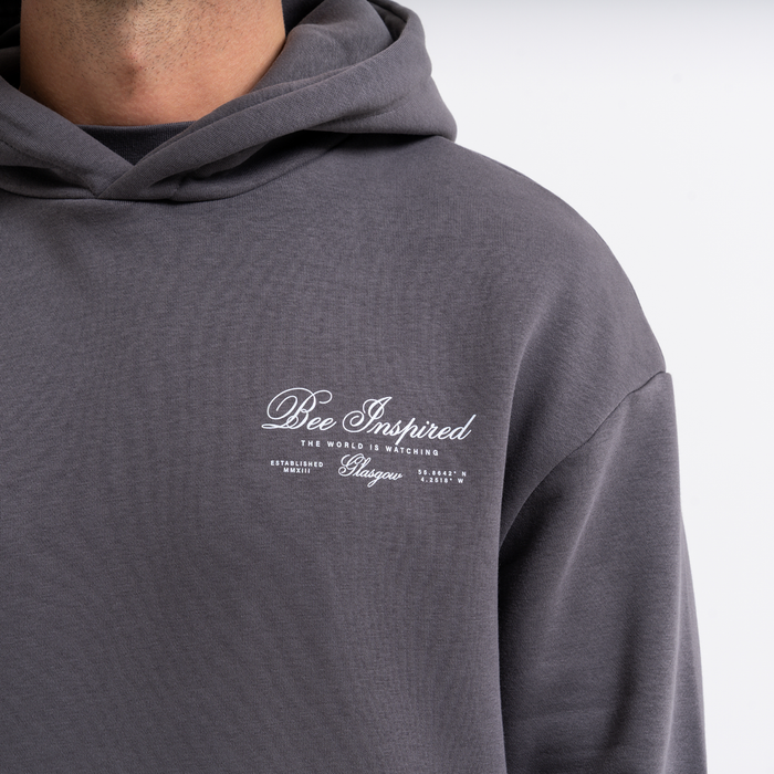 Grey hoodie with 'Bee Inspired' text on a white background