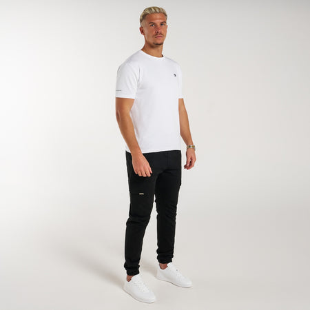 Rivero Cargo Pants in black with a metal branded pocket label