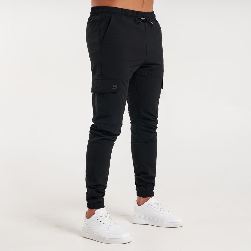 Rivero Tech Cargo Pants in black with a metal branded pocket label