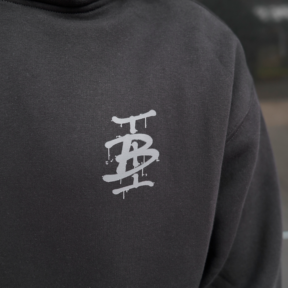 Bee Inspired Tonali Hoodie in Black, close-up of graffiti-style chest graphic detail