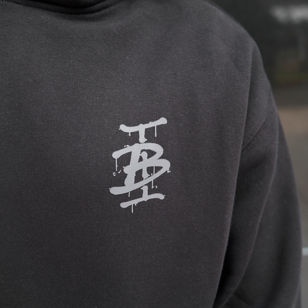 Bee Inspired Tonali Hoodie in Black, close-up of graffiti-style chest graphic detail